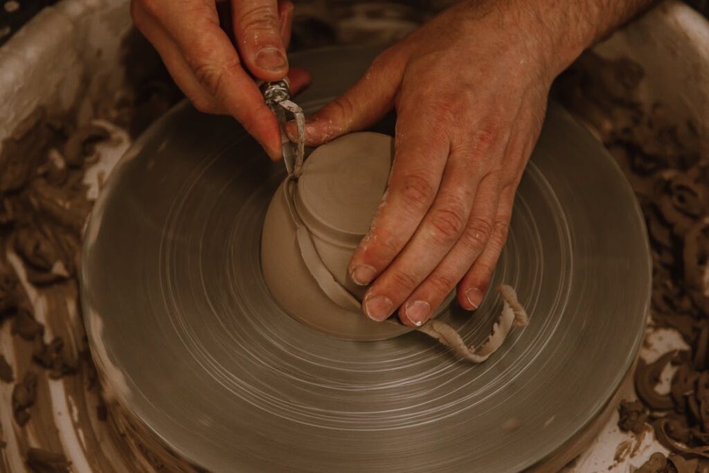 A potter creating a clay sculpture