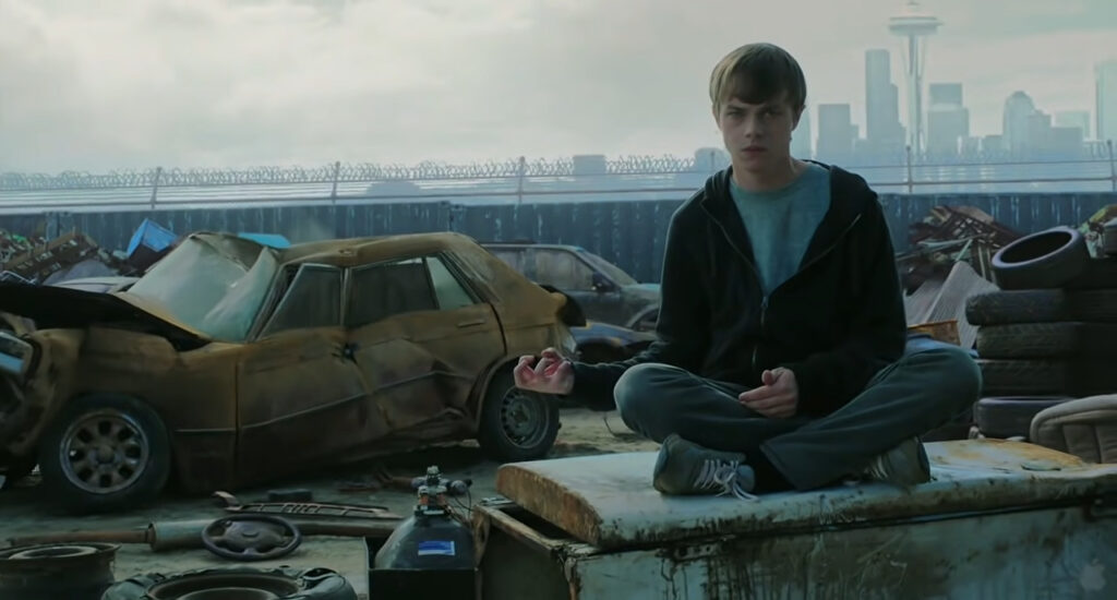 A teenage boy sits on a refrigerator in a junkyard while crushing a car with telekinetic powers. He uses the same powers to hold the camera, and this scene makes up part of the found footage.