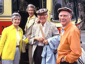 Frank Thomas (center) and Ollie Johnston (right) with their wives in 1985